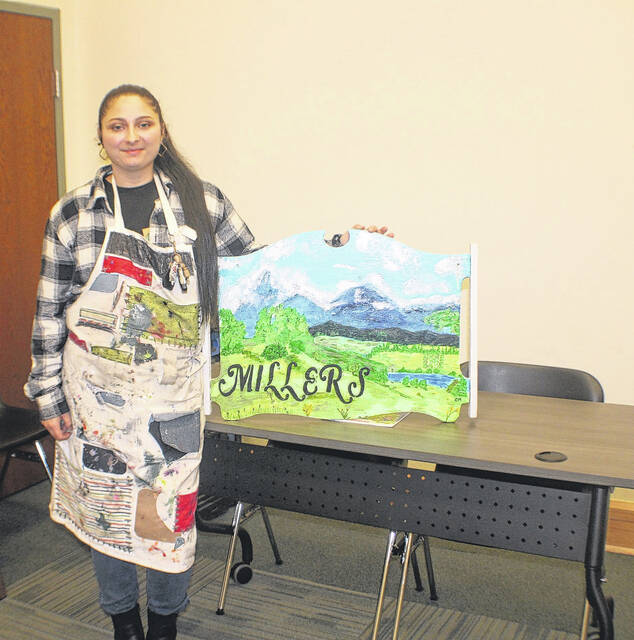<p>New Bennettsville and Co. vendor Courtney Medlin of Medlin Customs came to the library to sale her and her husband, Anthony Medlin’s wood carving offerings. “I’m the painter and he’s the wood cutter,” explains Courtney. “We do all custom projects- furniture, wood carvings, king size beds, vegetable boxes, chicken brooder boxes, end tables- you name it, we can pretty much do it. You know the Grinch cut outs in the window of Bennettsville and Co.? That’s us,” says Courtney.</p>
<p>Lauren Monica | Herald Advocate</p>