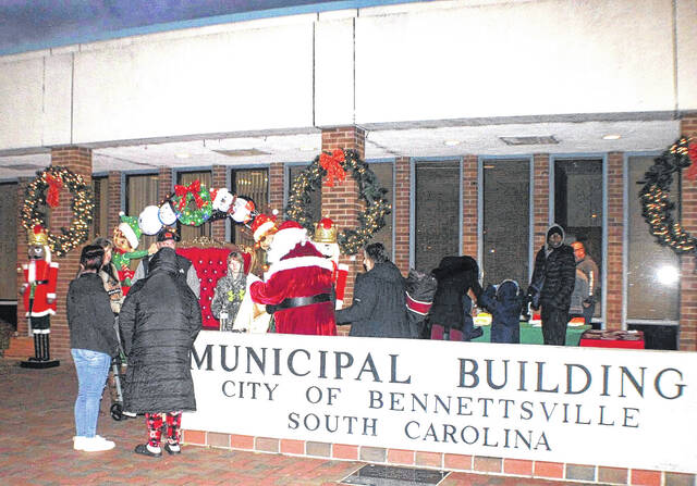 <p>The town of Bennettsville held its annual Christmas Tree lighting on Tuesday, December 9 at the Municipal Building. Outdoing themselves, Main Street Bennettsville had the area around the tree completely decked out in holiday cheer. Santa’s sleigh, light up decorations, and even a couple of nutcrackers to protect the Big Man’s chair and his bag of goodies were on display. In addition to Santa, the Grinch was sighted slinking into the gathering.</p>
<p>Lauren Monica | Herald-Advocate</p>