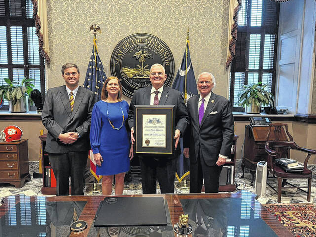SC Gov. Henry McMaster, right, presents the Order of the Palmetto award to Dr. Dowd, pictured center right next to his wife, Mrs. Kim Dowd, and Rep. G. Murrell Smith, Jr., Speaker of the SC House of Representatives, left, in the Office of the Governor on Feb. 11, 2026. (Courtesy photo).
