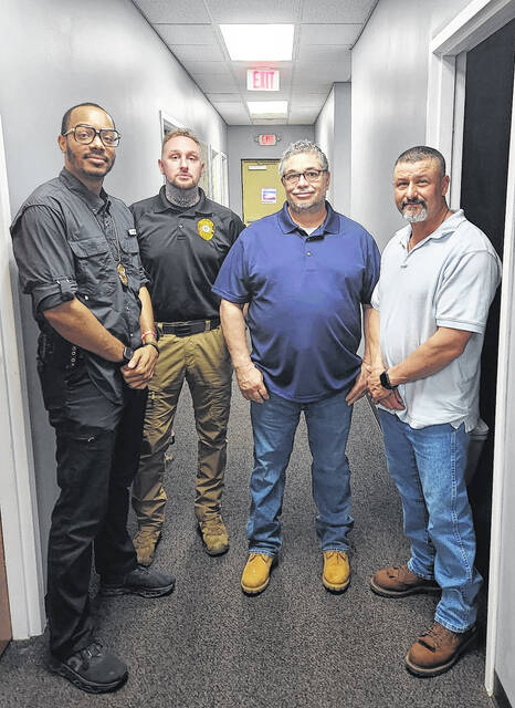 McColl Mayor Robert Outlaw poses with the towns newest hires: MPD Captain S. Wren, MPD Chief J. Beggs and Judge Kevin Treadaway.
                                 Submitted courtesy of Mayor Outlaw