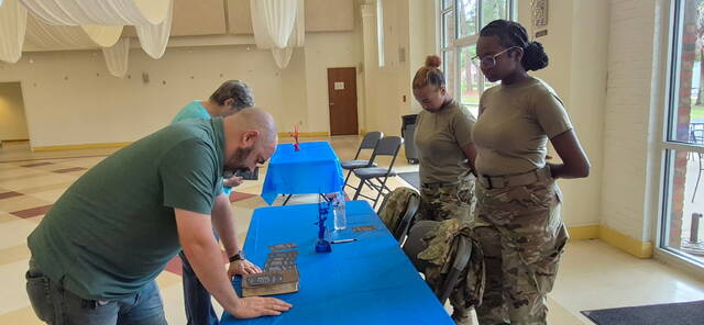 Pastor Jacob Orr prays with representatives from the Education branch of the Bennettsville community.
                                 Images provided courtesy of Mayor Tyron Abraham